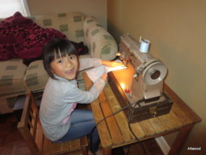 Using her Great-Nana's sewing machine.